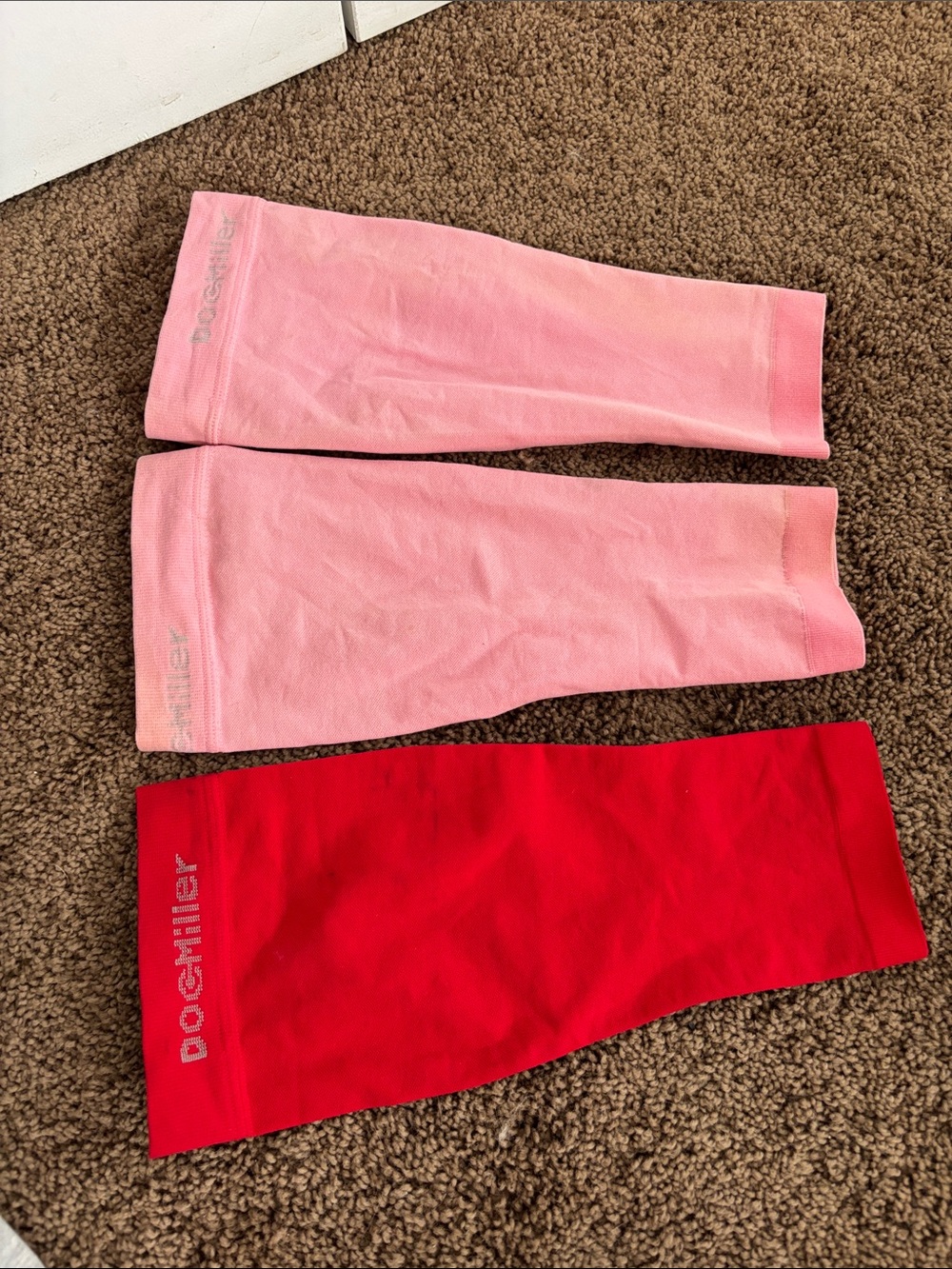 Doc Miller calf compression sleeves in pink and red. Pack of 3